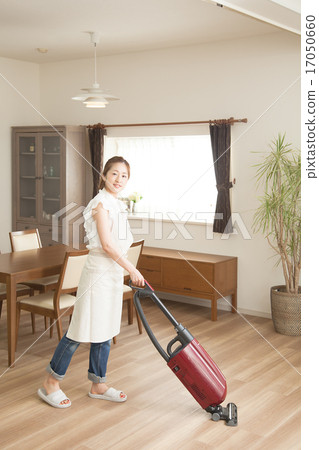 A woman doing housework in the dining room A woman doing housework in the dining room 17050660
