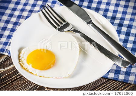 heart-shaped fried eggs in a plate heart-shaped fried eggs in a plate 17051860