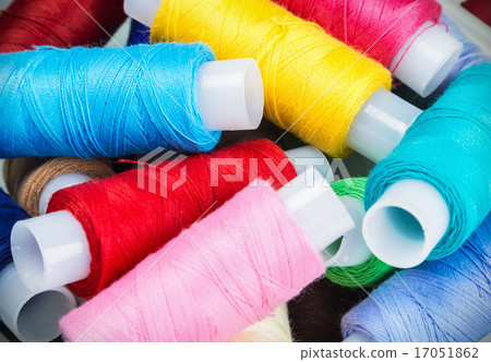 Multicolor sewing threads on background Multicolor sewing threads on background 17051862