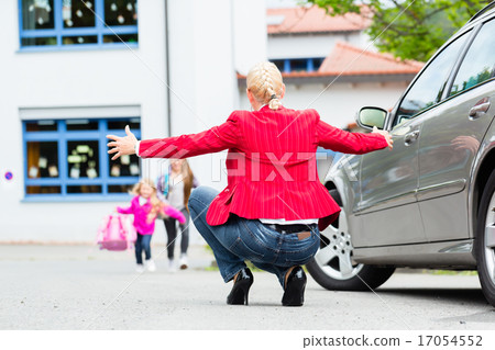 Mother hugging child after bringing her to school Mother hugging child after bringing her to school 17054552