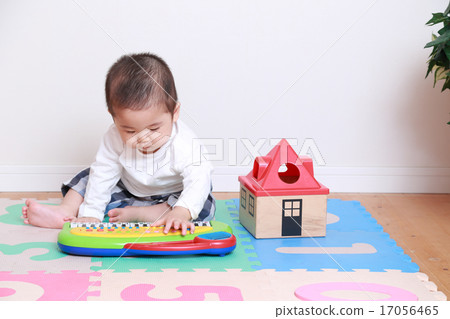 A 1 year old child playing with a toy 17056465
