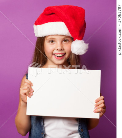 girl in red Santas hat with white board 17063797