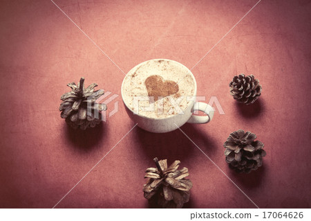 Cup of coffee with heart shape and pine cones Cup of coffee with heart shape and pine cones 17064626
