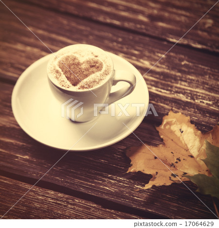 Autumn leafs and coffee cup on wooden table. Autumn leafs and coffee cup on wooden table. 17064629