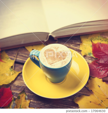 Autumn leafs, book and coffee cup on wooden table. Autumn leafs, book and coffee cup on wooden table. 17064630