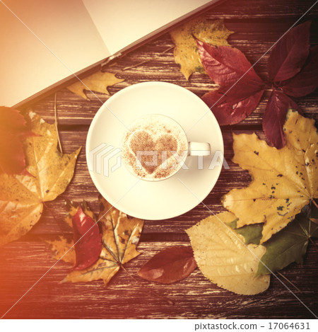 Autumn leafs, book and coffee cup on wooden table. 17064631