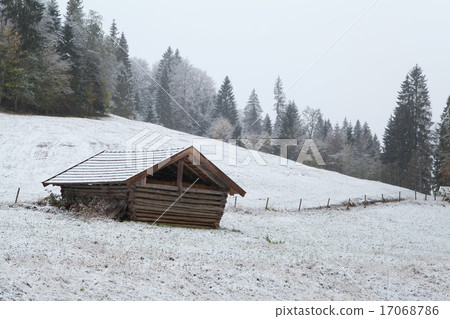 wooden hut on winter alpine meadow 17068786