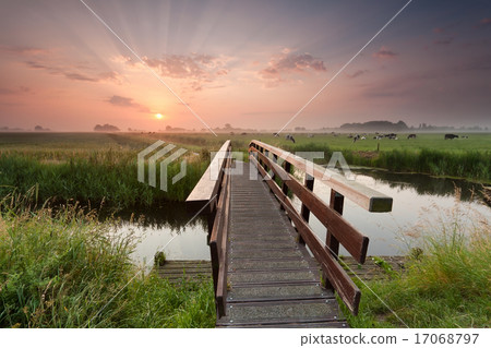 beautiful sunrise over bike bridge in farmland 17068797