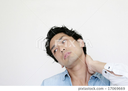 A young man with a low-eyed line holding his neck 17069669