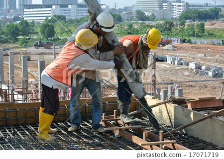 Construction Workers Using Concrete Hose Construction Workers Using Concrete Hose 17071719