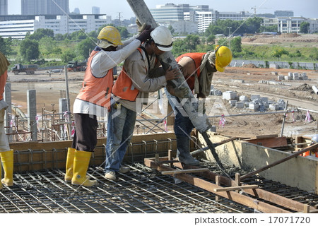 Construction Workers Using Concrete Hose 17071720