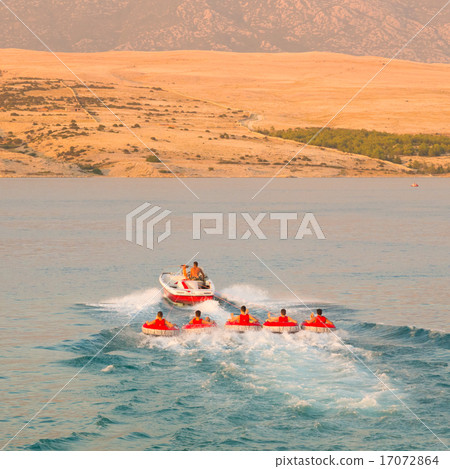 Kids tube riding tawed by speedboat. Kids tube riding tawed by speedboat. 17072864