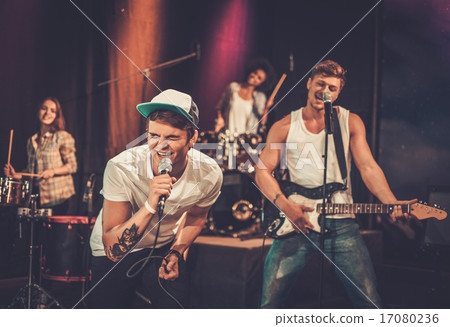 Multiracial music band performing on a stage Multiracial music band performing on a stage 17080236