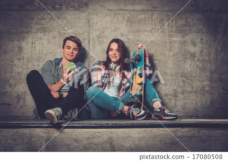 Young couple with skateboard  outdoors 17080508