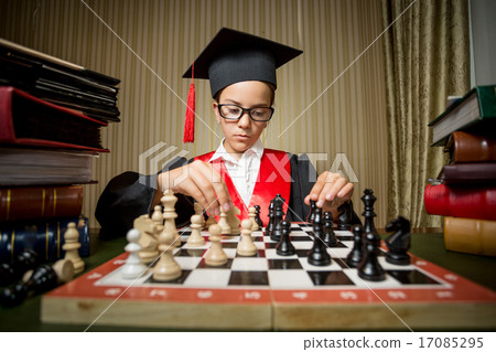 girl in graduation cap playing chess with herself girl in graduation cap playing chess with herself 17085295