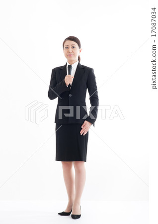 Full body pose of a woman holding a microphone Full body pose of a woman holding a microphone 17087034