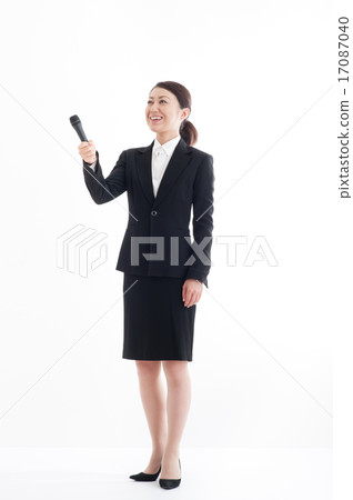Full body pose of a woman holding a microphone Full body pose of a woman holding a microphone 17087040