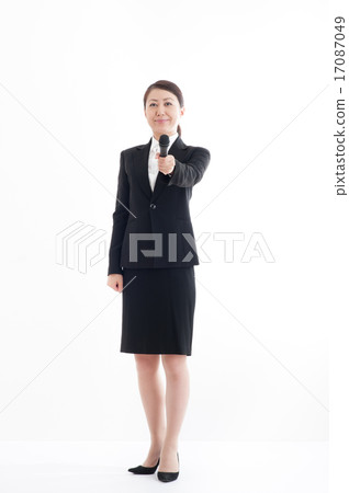 Full body pose of a woman holding a microphone 17087049