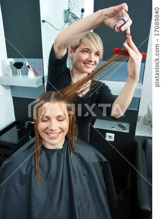 hair stylist working on haircut hair stylist working on haircut 17089840