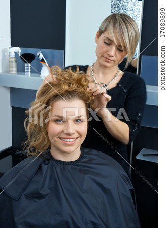 hair stylist curling woman hair hair stylist curling woman hair 17089899