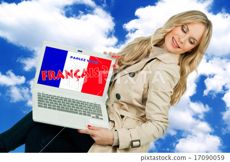 woman holding laptop with french language sign woman holding laptop with french language sign 17090059