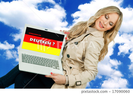 woman holding laptop with german language sign woman holding laptop with german language sign 17090060