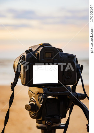 Digital camera on the tripod isolated white screen 17090144