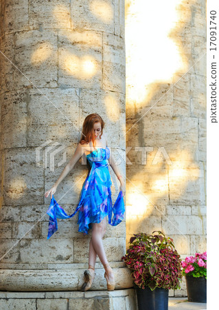 Ballerina is dancing near the column 17091740