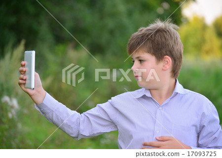 Teen boy with  tablet computer at nature 17093725