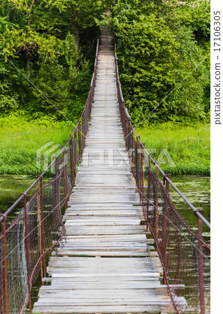 Hanging bridge. Bridge goes over river 17106305