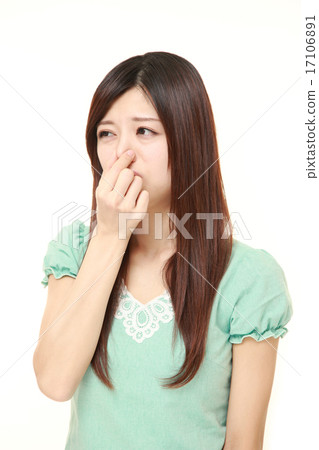 A woman holding a nose 17106891