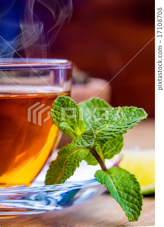Tea in a glass cup, mint leaves, dried tea, sliced 17108708