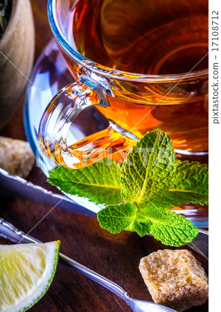 Tea in a glass cup, mint leaves, dried tea, sliced 17108712