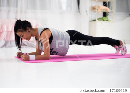 Slim fitness young woman Athlete girl doing plank exercise at home concept training workout crossfit 17109619