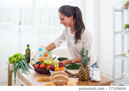 Woman preparing dinner in a kitchen concept cooking, culinary, healthy lifestyle. Woman preparing dinner in a kitchen concept cooking, culinary, healthy lifestyle. 17109684