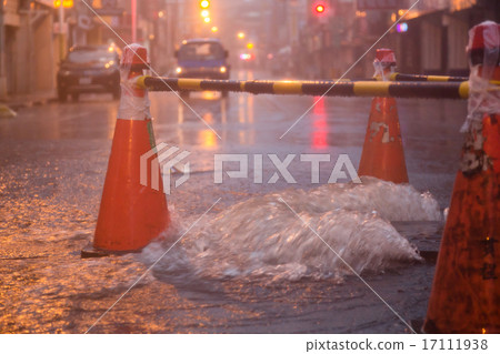 Orange cones around overflowing manhole Orange cones around overflowing manhole 17111938