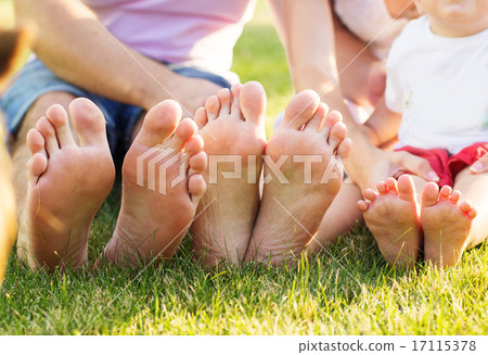 Closeup of feets lying in line at green grass Closeup of feets lying in line at green grass 17115378
