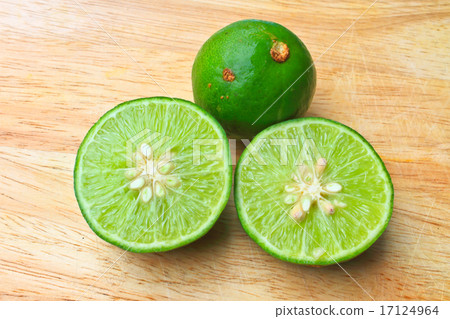 Fresh organic cut limes on wooden cutting board Fresh organic cut limes on wooden cutting board 17124964