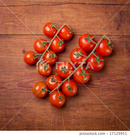 Tomato branch on vintage wood table Tomato branch on vintage wood table 17129951