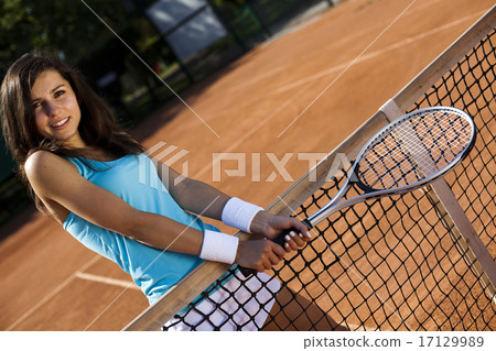 Girl playing tennis on the court 17129989