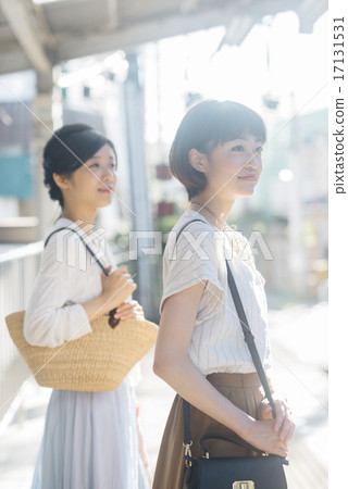 Two girls waiting for a train Two girls waiting for a train 17131531