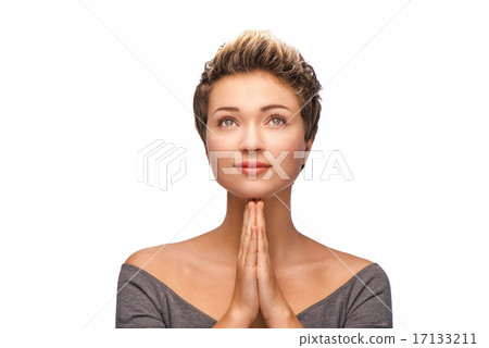 Woman with copper-colored hair praying 17133211