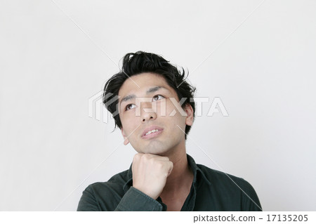 A young man looking up with a cheek A young man looking up with a cheek 17135205