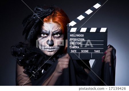 Stock Photo: Scary monster with movie board