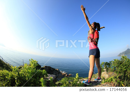 cheering young fitness woman open armsseaside   17144056