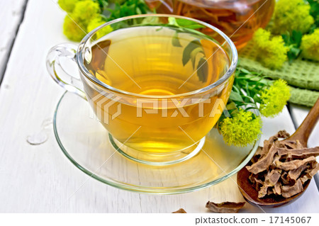 Tea of Rhodiola rosea in cup with spoon on light board 17145067