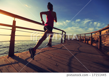 young fitness woman legs running on seaside wooden boardwalk young fitness woman legs running on seaside wooden boardwalk 17151445