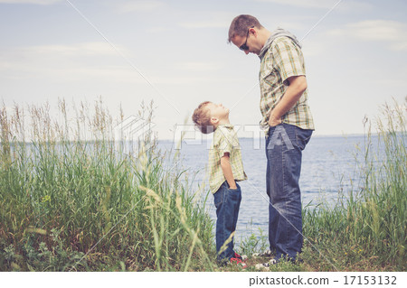 Father and son playing at the park near lake at the day time. 17153132