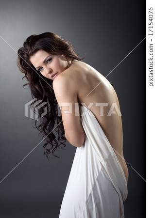 Beautiful curly brunette posing curving at camera 17154076