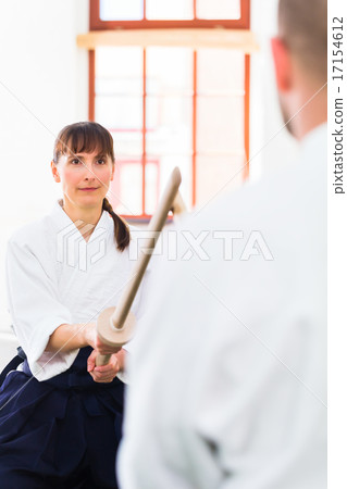 Man and woman having Aikido sword fight 17154612